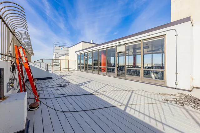 a view of balcony with wooden floor and dining space