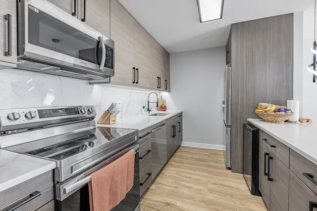 a kitchen with stainless steel appliances a sink stove and cabinets