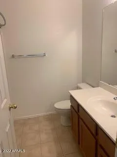 a bathroom with a granite countertop toilet and a sink