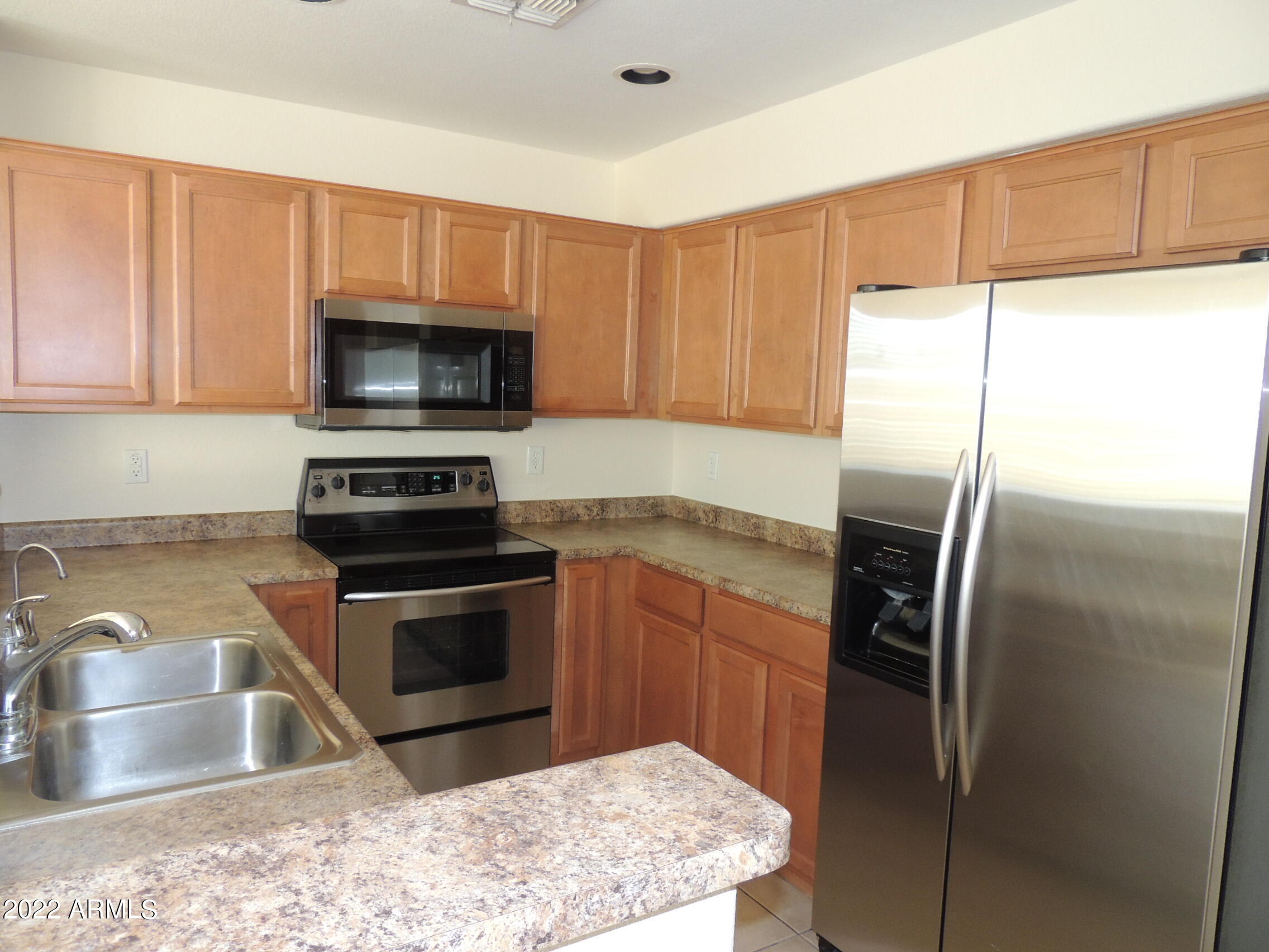 1886 East Don Carlos, Unit 165 Tempe, AZ 85281 - Photo 4 of 34 a kitchen with granite countertop a refrigerator and a sink
