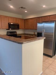 1886 East Don Carlos, Unit 165 Tempe, AZ 85281 - Photo 6 of 34 a kitchen with kitchen island a counter top space cabinets and stainless steel appliances