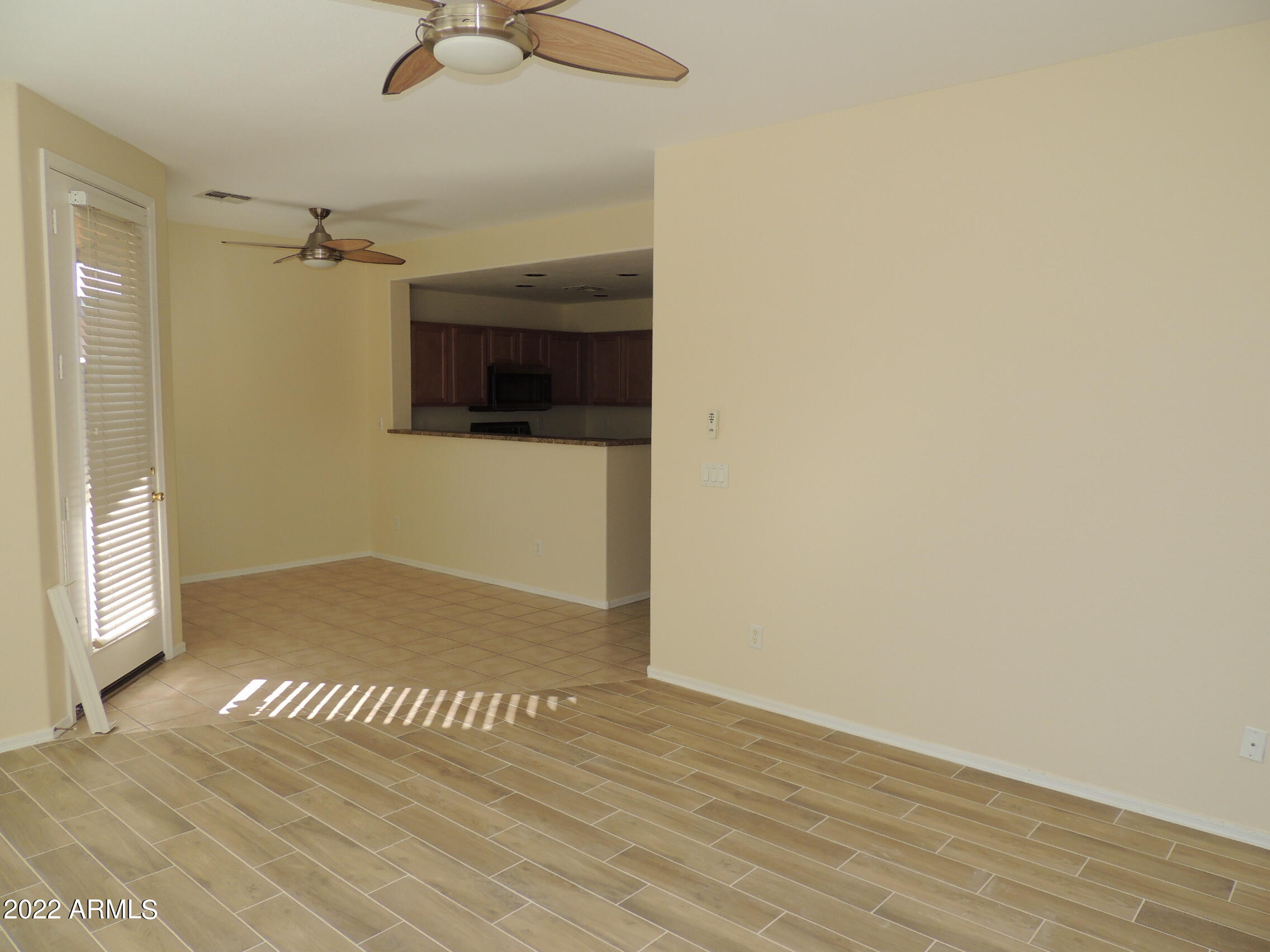 1886 East Don Carlos, Unit 165 Tempe, AZ 85281 - Photo 9 of 34 a view of a livingroom with wooden floor and a ceiling fan