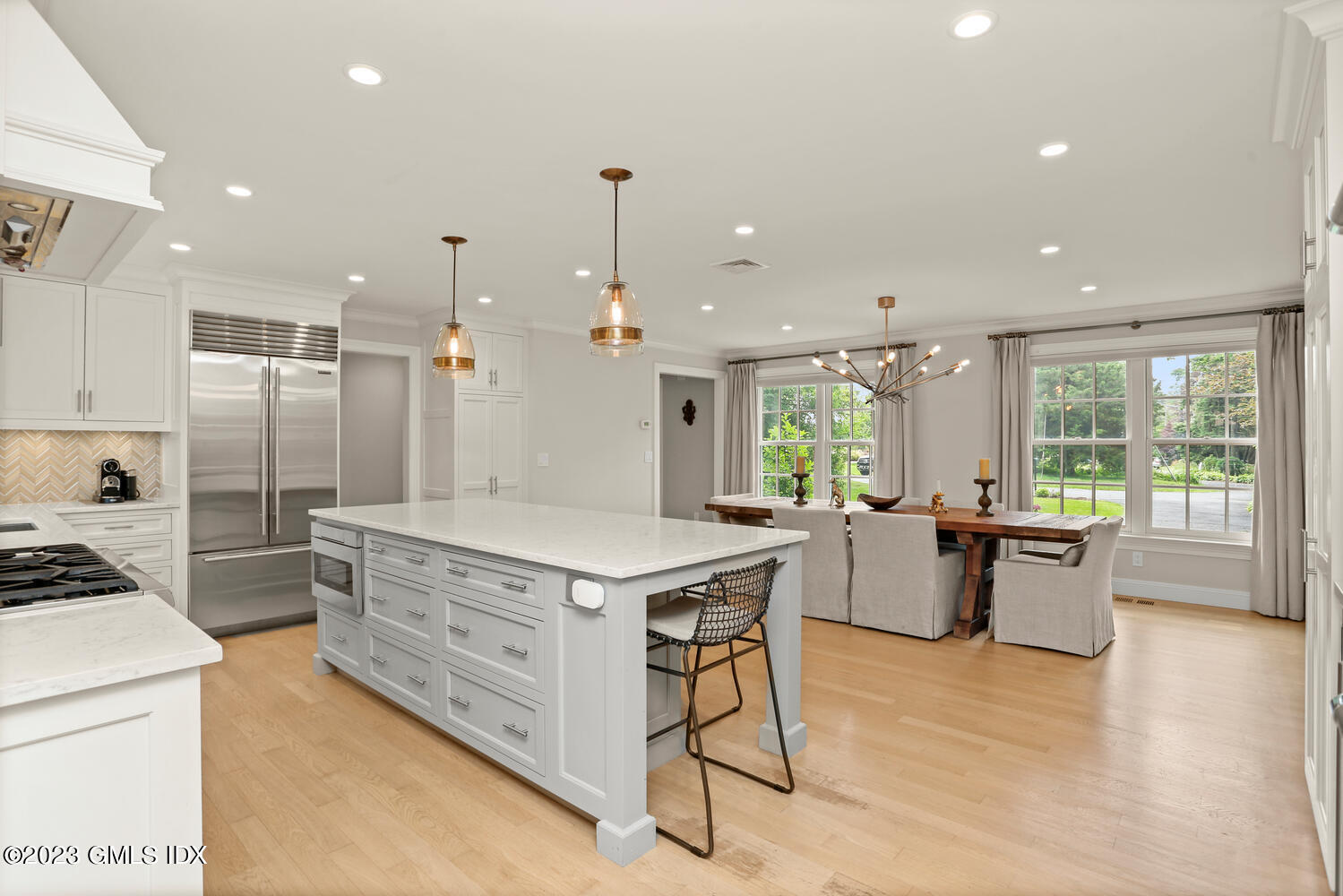 18 Candlelight Place Greenwich, CT 06830 - Photo 11 of 29 a kitchen with a stove a refrigerator a sink dishwasher with a dining table and chairs