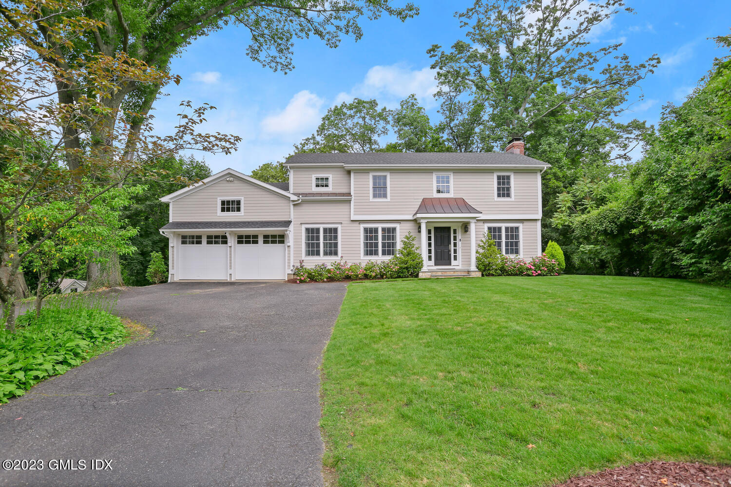 18 Candlelight Place Greenwich, CT 06830 - Photo 2 of 29 a front view of a house with a yard