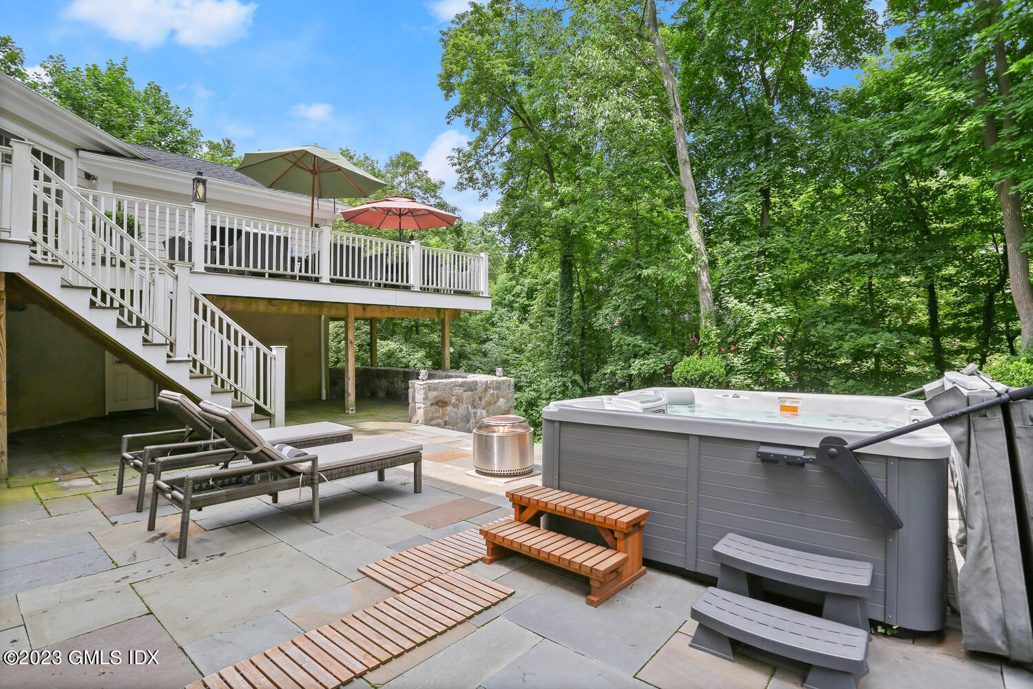 18 Candlelight Place Greenwich, CT 06830 - Photo 23 of 29 a view of a patio with couches table and chairs with wooden fence and floor