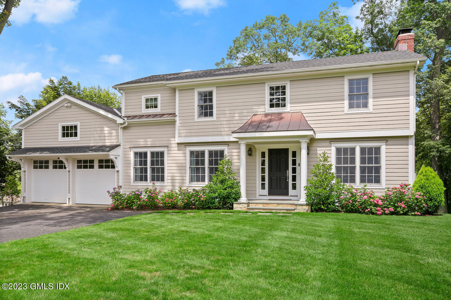 18 Candlelight Place Greenwich, CT 06830 - Photo 3 of 29 a front view of a house with a garden