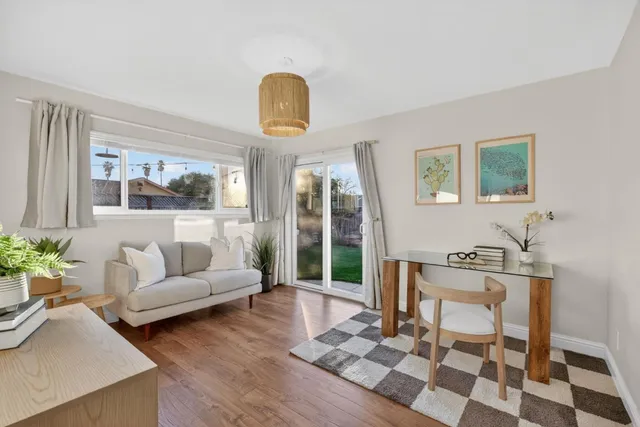 a living room with furniture and wooden floor