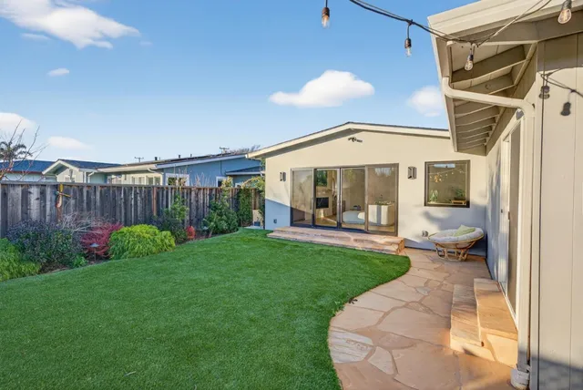 a view of a chair and table in backyard