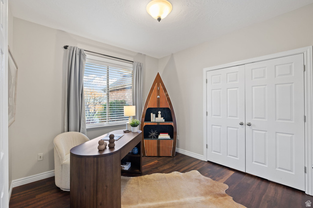 6208 West Bull River Road Highland, UT 84003 - Photo 14 of 90 Room featuring dark wood-finish flooring, light neutral-toned walls, and a multi-paned window with blinds