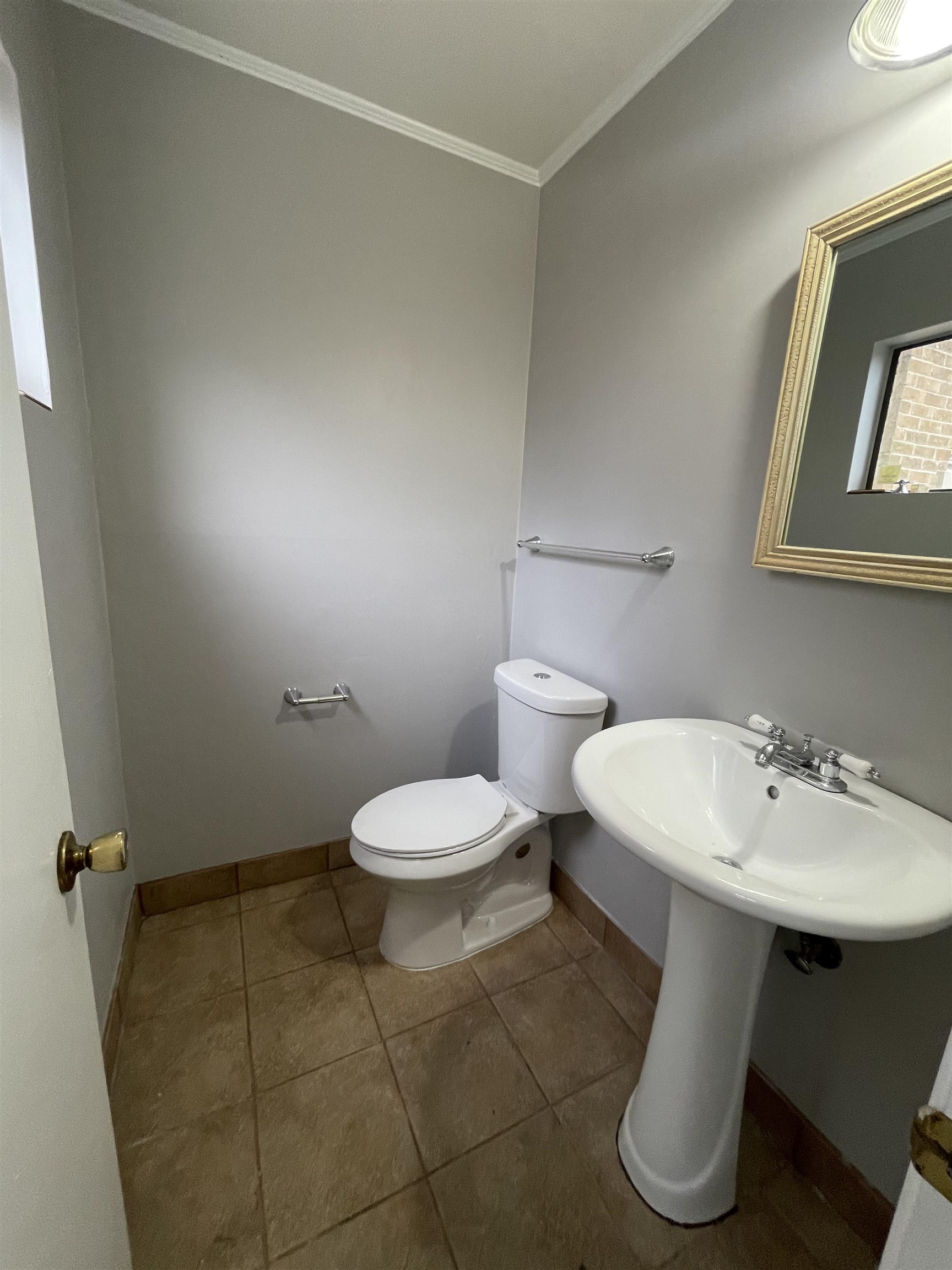 885 Echles Street Memphis, TN 38111 - Photo 13 of 18 a bathroom with a toilet sink and mirror