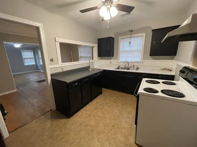 a kitchen that has a sink and a stove in it