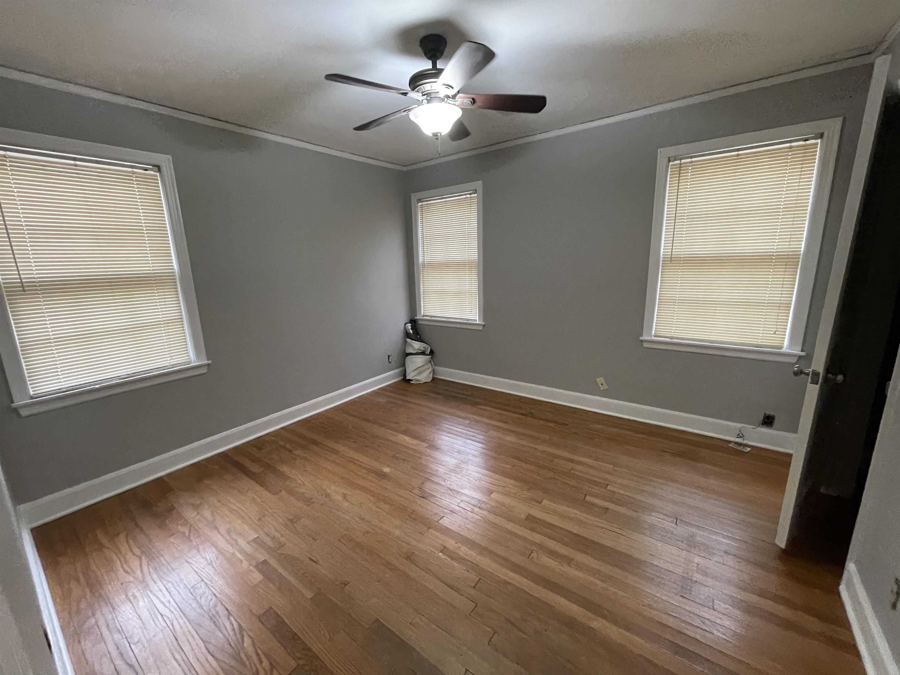 885 Echles Street Memphis, TN 38111 - Photo 9 of 18 a view of an empty room with wooden floor and a window