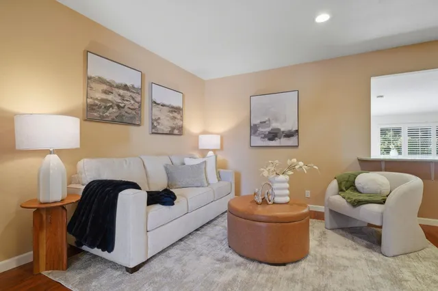 a living room with furniture and a lamp