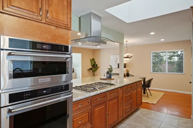 a kitchen with stainless steel appliances a stove and a microwave