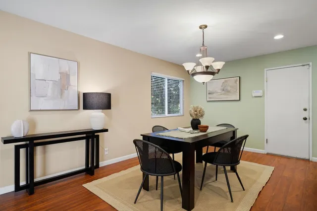a view of a dining room with furniture and wooden floor