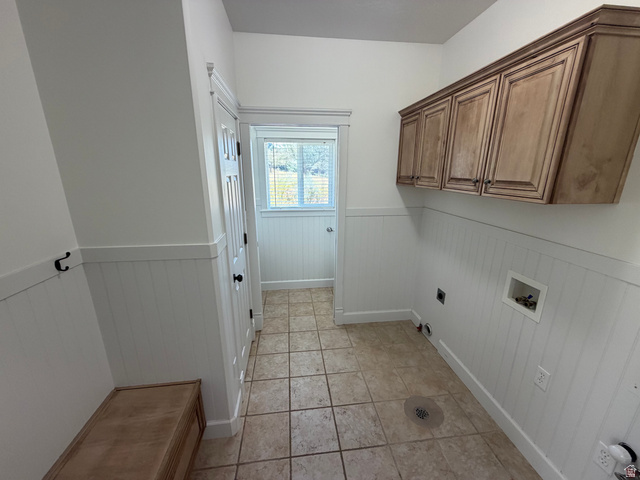240 Bugle Way Providence, UT 84332 - Photo 20 of 33 Utility space featuring light wood-finish cabinetry, wainscoting, and tile flooring