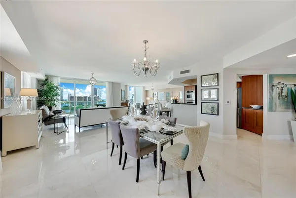 a view of a dining room with furniture and chandelier