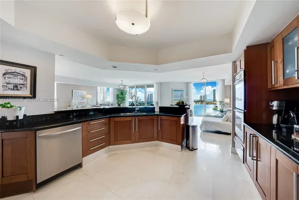 a kitchen with granite countertop a sink and cabinets