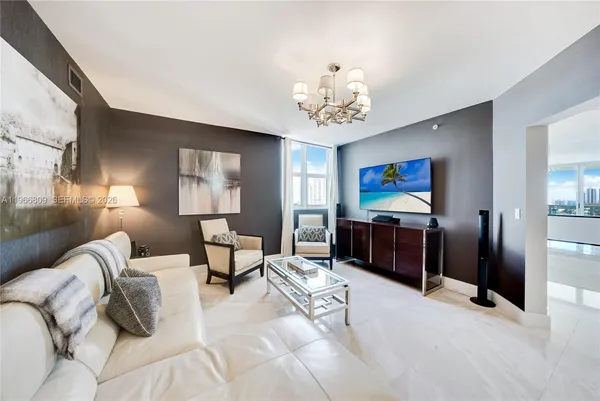 a spacious bedroom with a bed and a chandelier