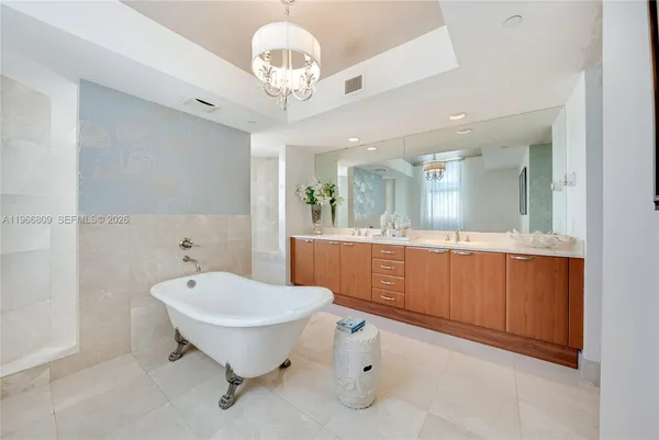 a spacious bathroom with a sink and a mirror