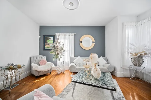 a living room with furniture rug and lamp