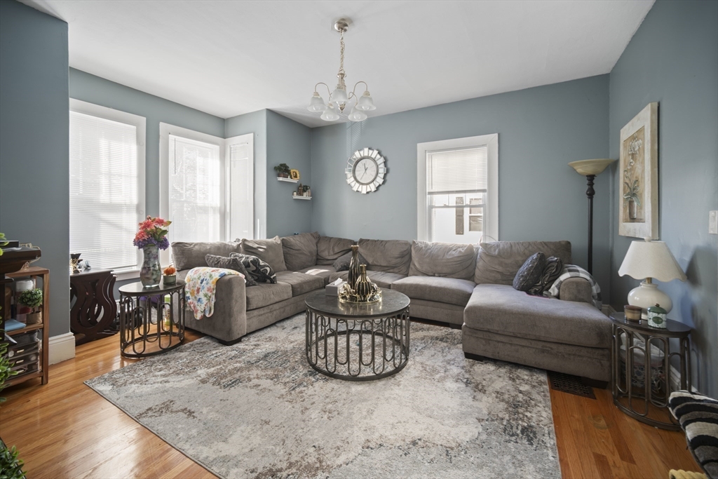 14-16 Dexter Street Lynn, MA 01902 - Photo 15 of 33 a living room with furniture a large window and a chandelier