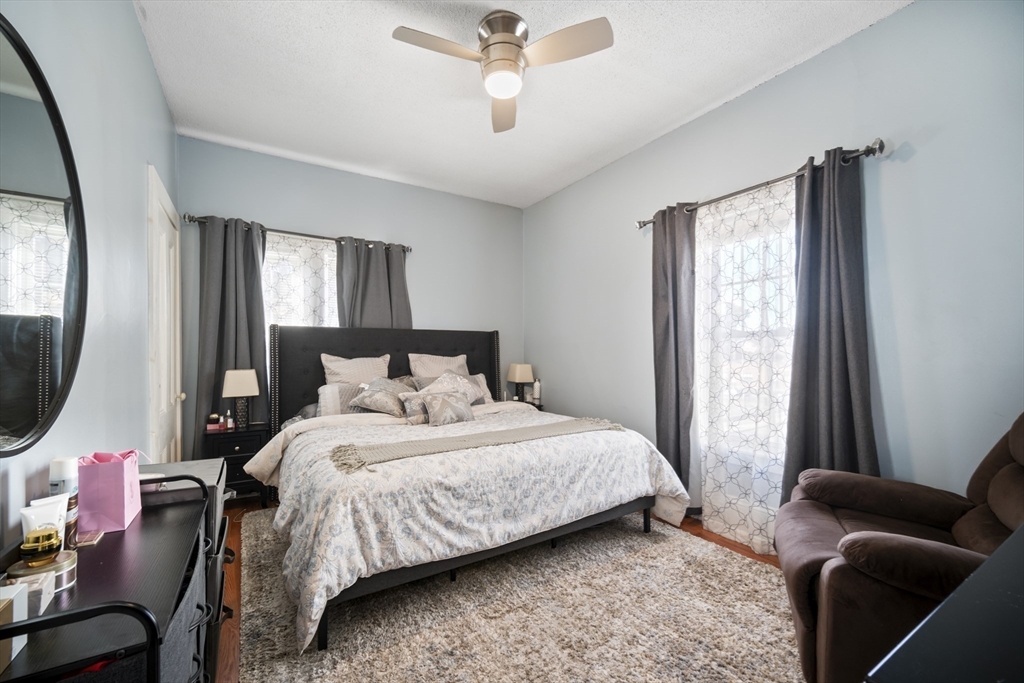 14-16 Dexter Street Lynn, MA 01902 - Photo 17 of 33 a bedroom with a bed a couch and a window