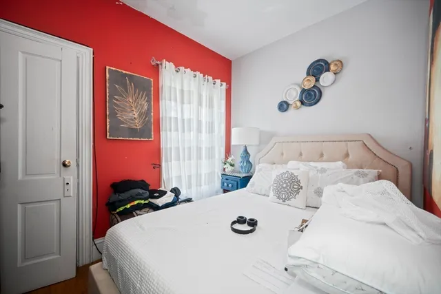 a bedroom with a bed and a chandelier