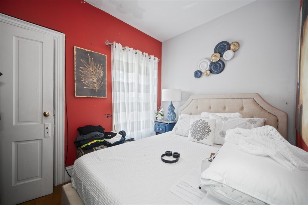 14-16 Dexter Street Lynn, MA 01902 - Photo 21 of 33 a bedroom with a bed and a chandelier