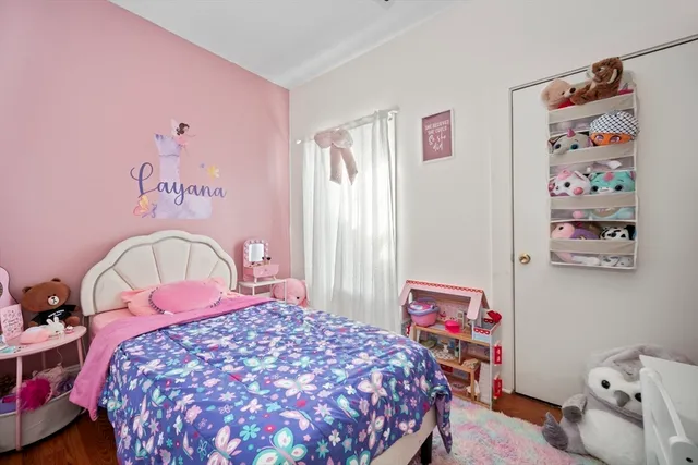 a bedroom with a bed and a dresser