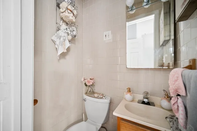 a bathroom with a sink mirror and toilet