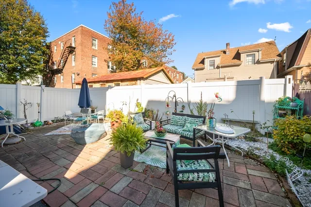a view of a patio with table and chairs and potted plants