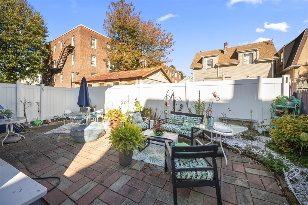 14-16 Dexter Street Lynn, MA 01902 - Photo 29 of 33 a view of a patio with table and chairs and potted plants