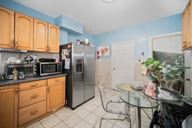 a kitchen with stainless steel appliances white cabinets and a refrigerator