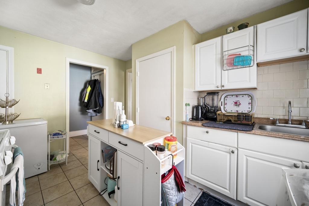 14-16 Dexter Street Lynn, MA 01902 - Photo 8 of 33 a kitchen with a sink stove and cabinets