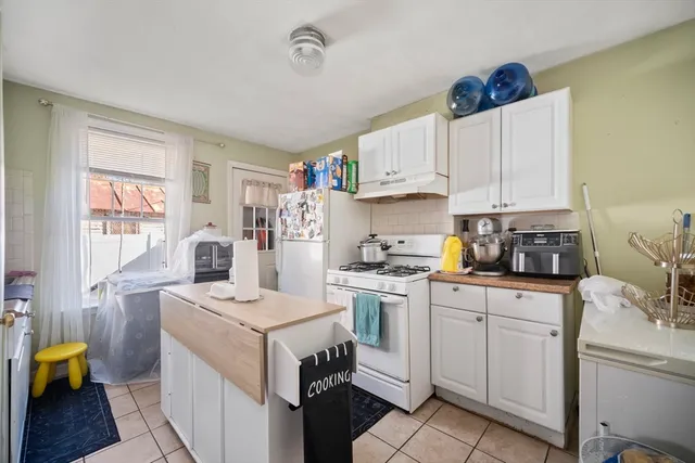 a kitchen with a sink a stove cabinets and counter space