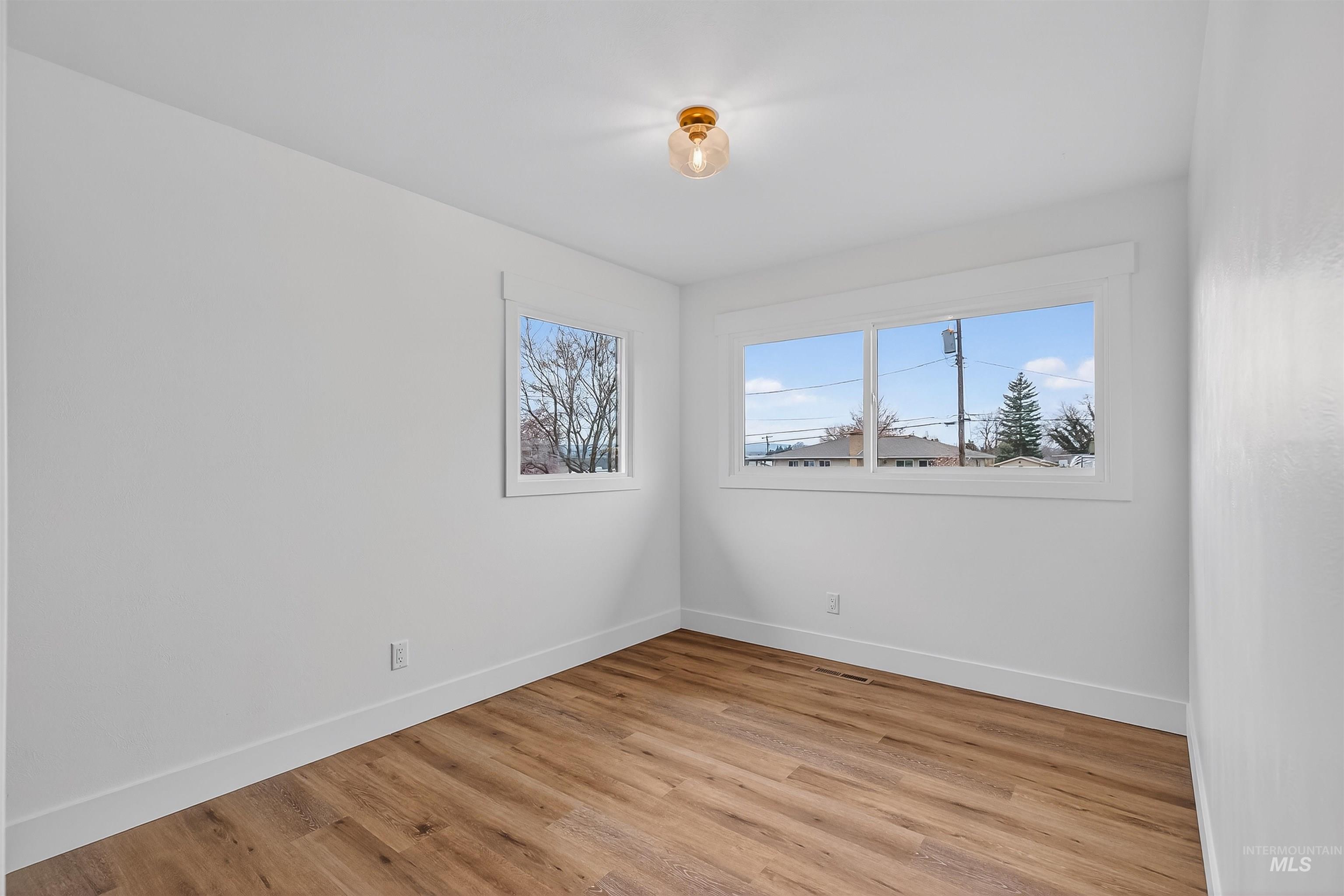 3513 8th Street Lewiston, ID 83501 - Photo 32 of 41 Unfurnished room with light wood-style floors and baseboards