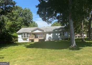 a front view of a house with a yard table and chairs