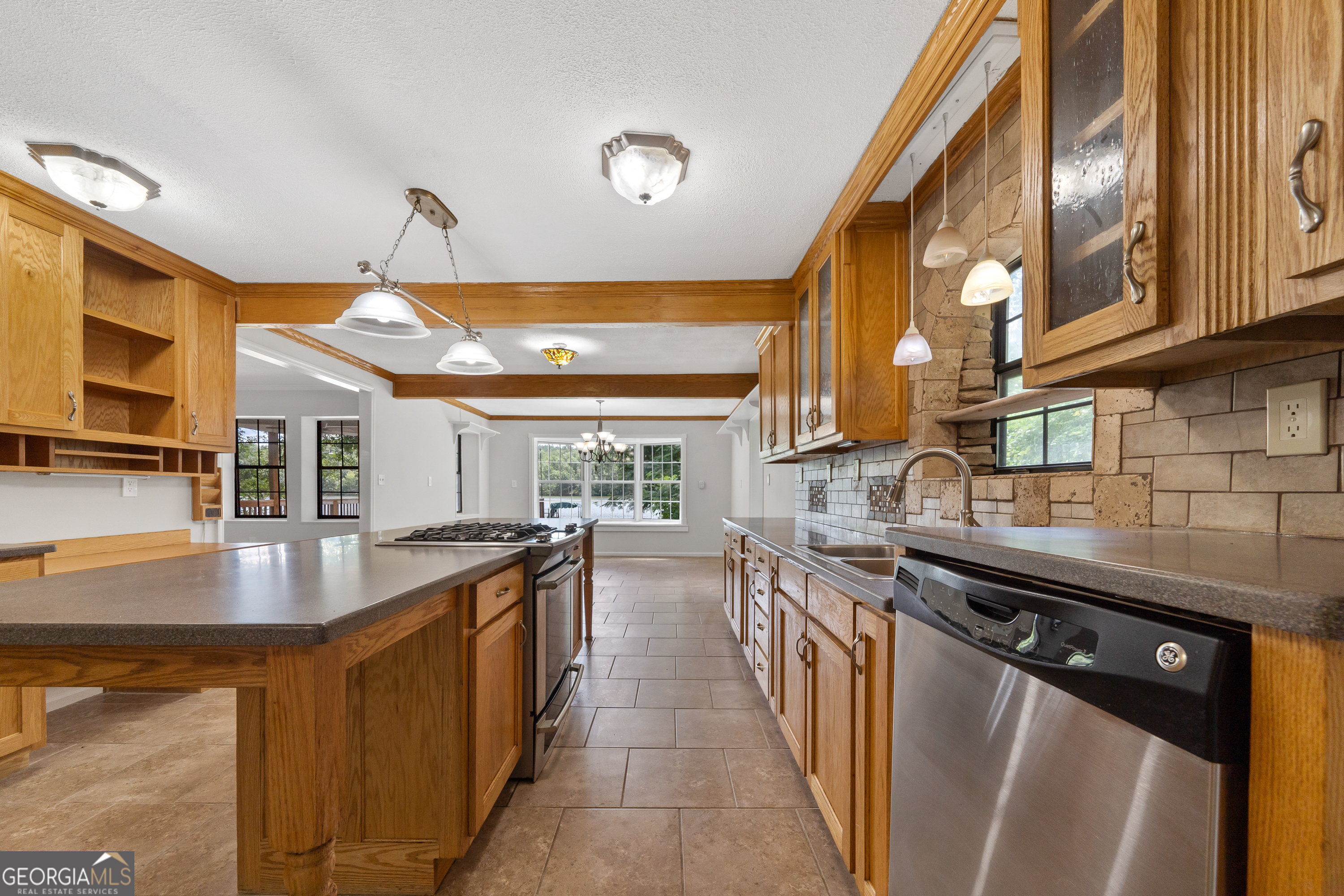 274 South Steel Bridge Road Eatonton, GA 31024 - Photo 11 of 39 a kitchen with stainless steel appliances granite countertop a sink and stove