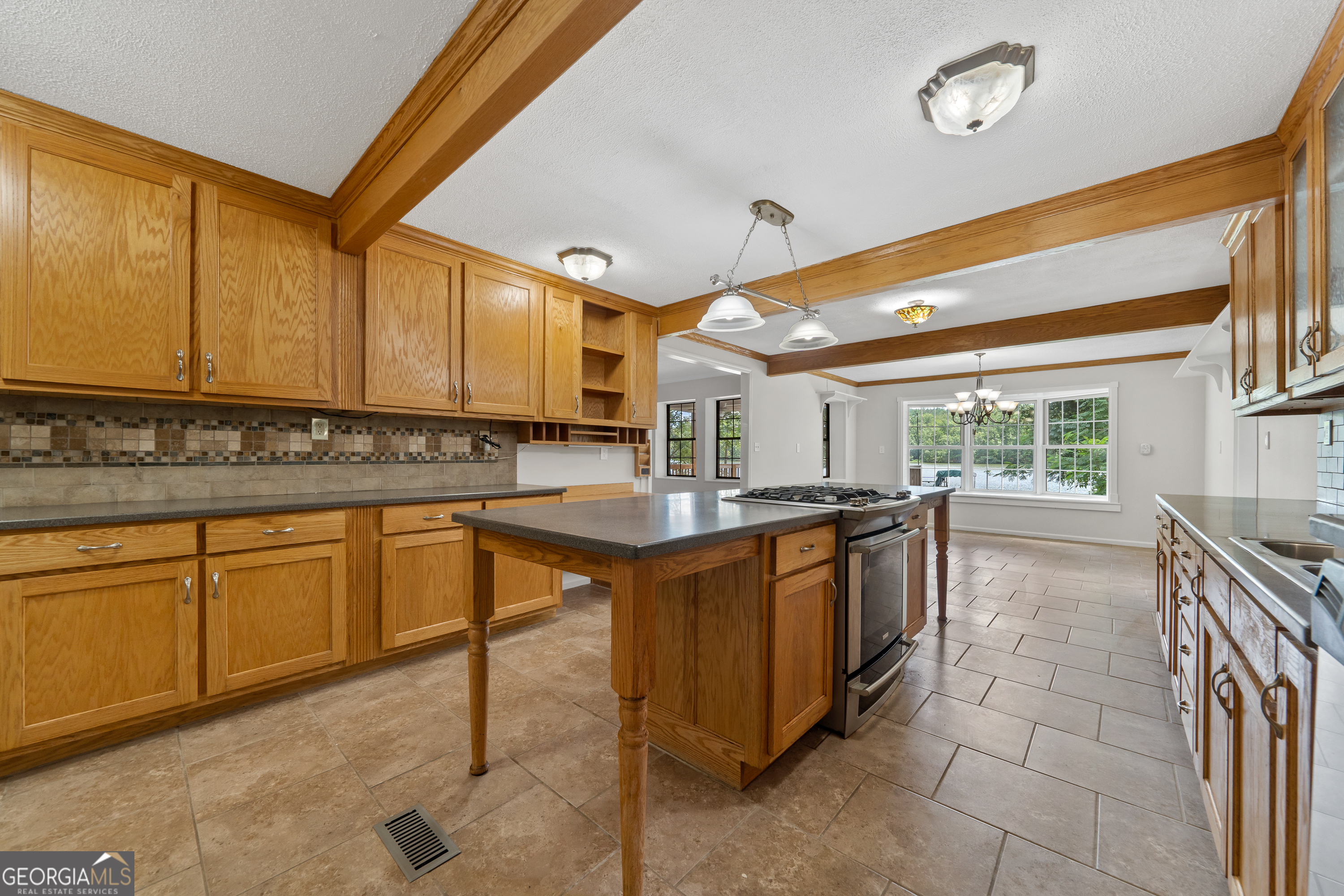 274 South Steel Bridge Road Eatonton, GA 31024 - Photo 12 of 39 a kitchen with stainless steel appliances granite countertop sink stove and cabinets