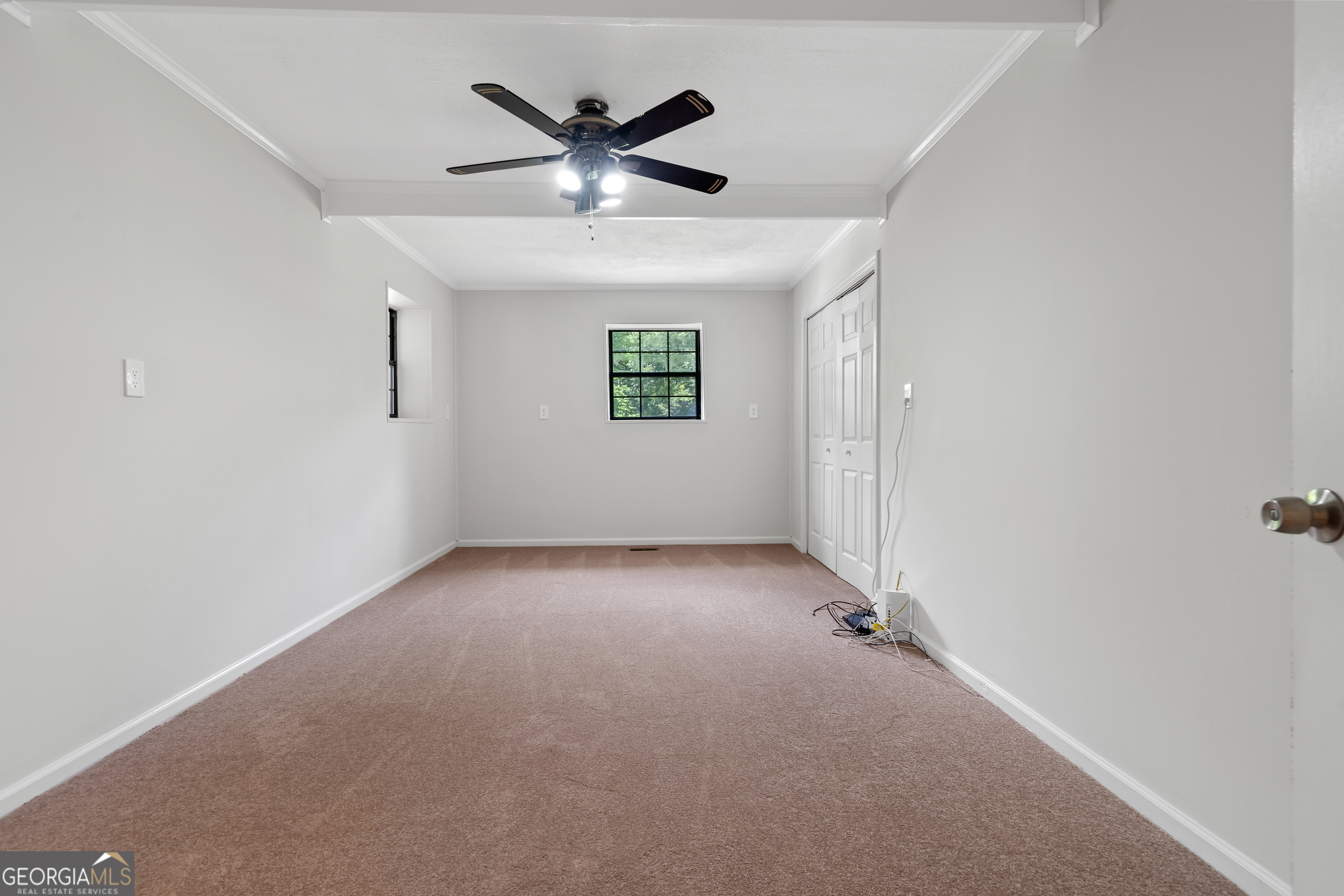 274 South Steel Bridge Road Eatonton, GA 31024 - Photo 18 of 39 an empty room with a ceiling fan and window