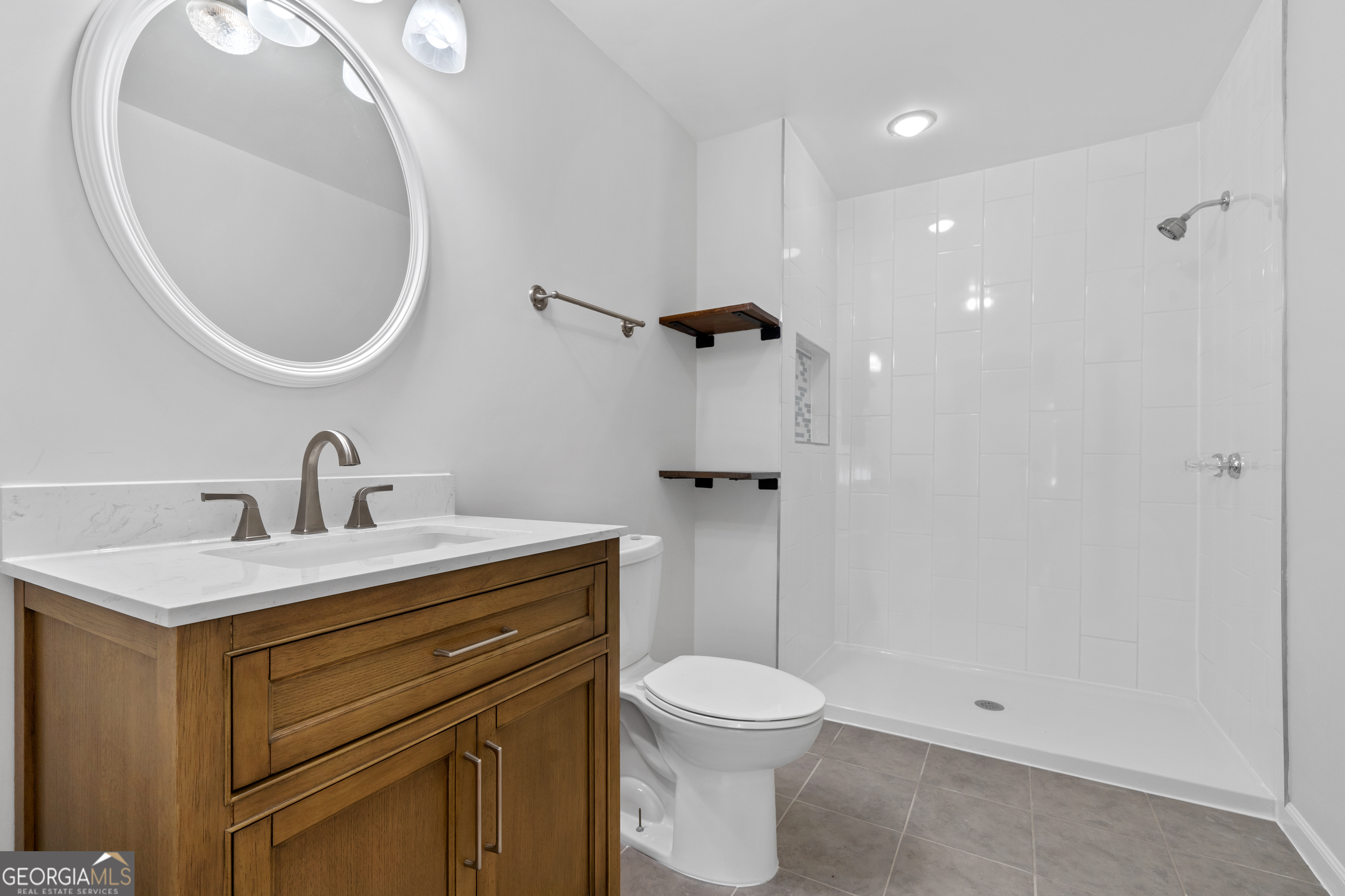 274 South Steel Bridge Road Eatonton, GA 31024 - Photo 19 of 39 a bathroom with a sink a toilet and a mirror