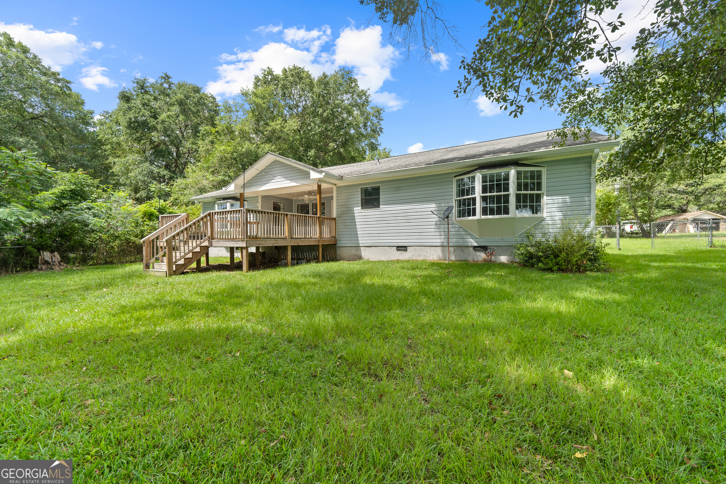 274 South Steel Bridge Road Eatonton, GA 31024 - Photo 32 of 39 a front view of a house with a yard and trees
