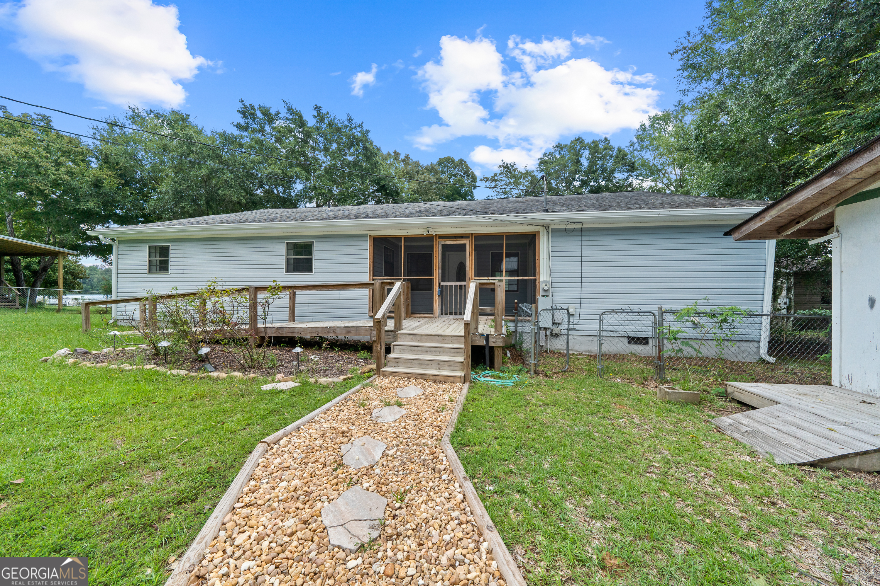 274 South Steel Bridge Road Eatonton, GA 31024 - Photo 36 of 39 a view of a house with backyard and sitting area