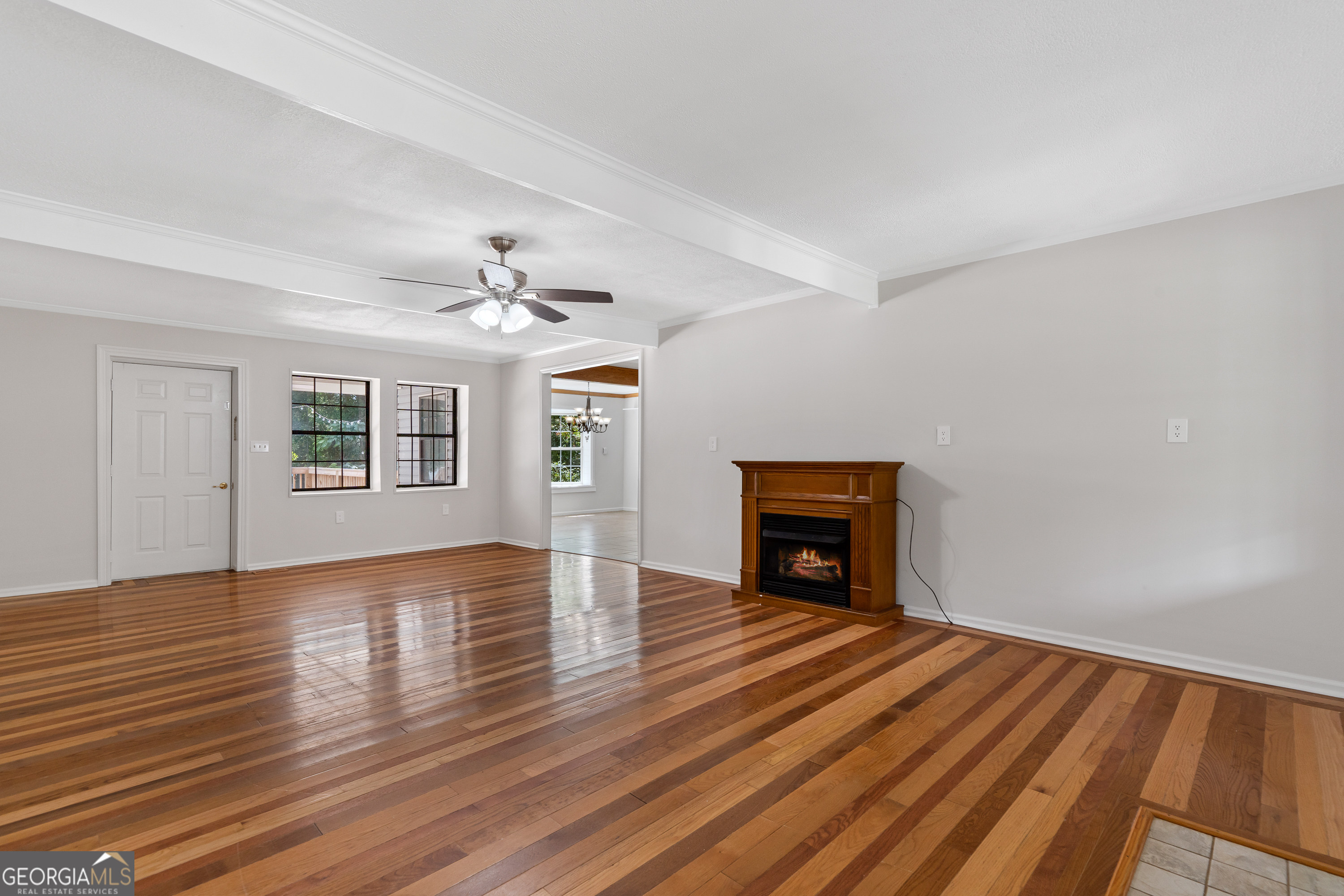274 South Steel Bridge Road Eatonton, GA 31024 - Photo 5 of 39 a view of empty room with wooden floor and fan