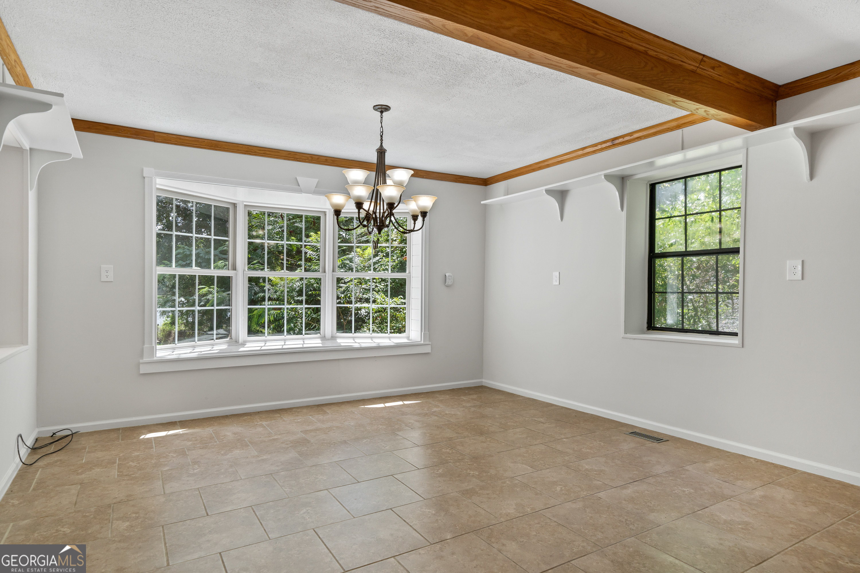 274 South Steel Bridge Road Eatonton, GA 31024 - Photo 6 of 39 an empty room with chandelier fan and windows