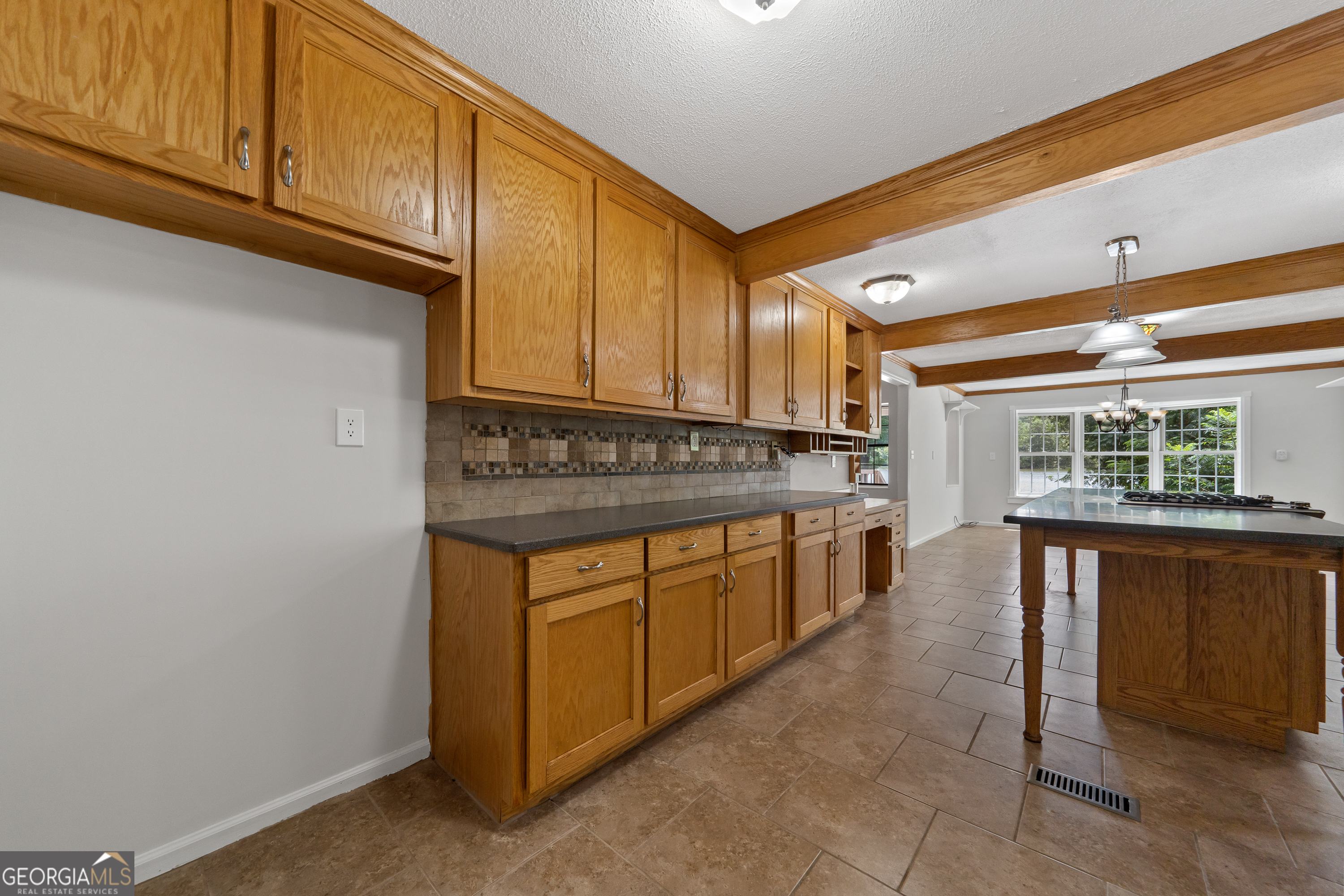 274 South Steel Bridge Road Eatonton, GA 31024 - Photo 10 of 39 a kitchen with stainless steel appliances granite countertop a stove a sink and a microwave