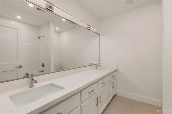 a bathroom with a shower and a sink