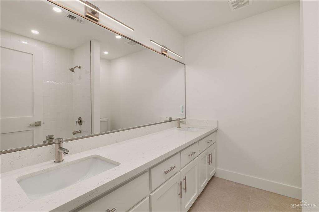 34732 Kretz Road, Unit 2 Los Fresnos, TX 78566 - Photo 12 of 22 a bathroom with a sink and a mirror