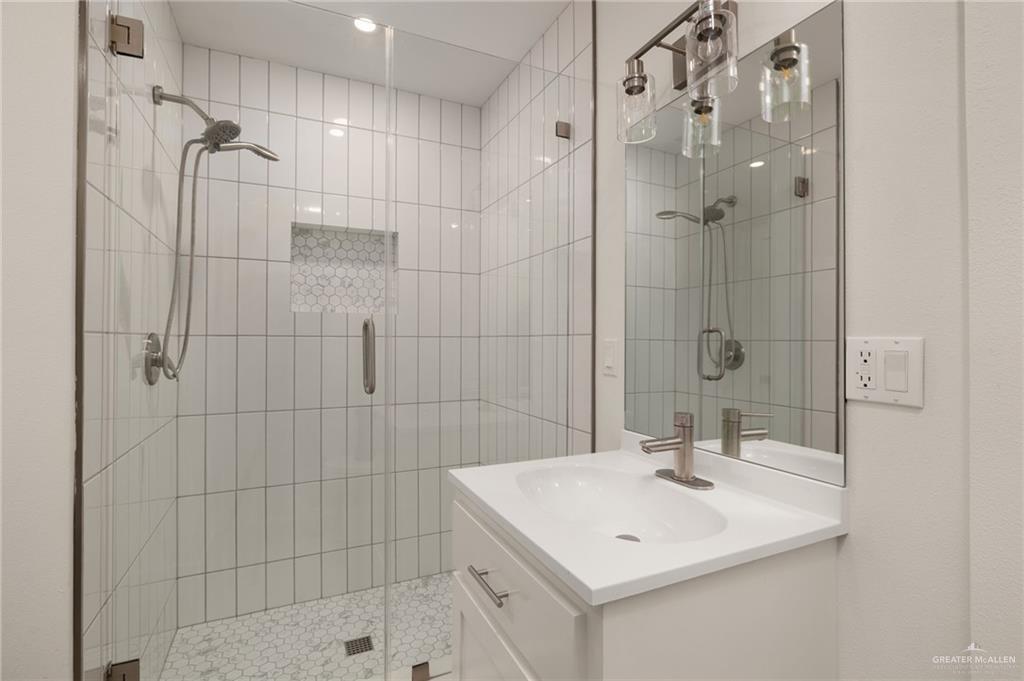 34732 Kretz Road, Unit 2 Los Fresnos, TX 78566 - Photo 13 of 22 a bathroom with a sink a shower and a mirror